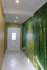 a hallway with a green wall with a door at Annam House in Bad Sooden-Allendorf