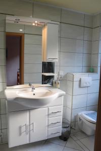 uma casa de banho branca com um lavatório e um WC em Annam House em Bad Sooden-Allendorf