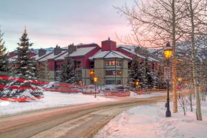 a snow covered street in front of a large building at Longbranch 317 Evergreen Condo Nice Location Updates in Breckenridge