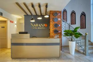 a lobby with a narma hotel boutique sign on the wall at Naranjo Hotel Boutique in Higuey