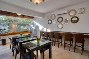 une salle à manger avec des tables, des chaises et un comptoir dans l'établissement Naranjo Hotel Boutique, à Higuey