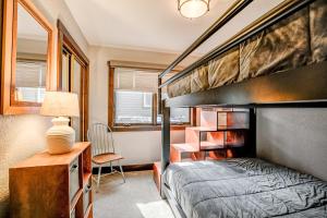 a bedroom with a bunk bed and a desk and a chair at Wendall Square Condo Great Breck Location in Breckenridge