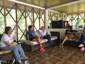 a group of women sitting on couches in a room at Reserva Yavary Tucano in Leticia