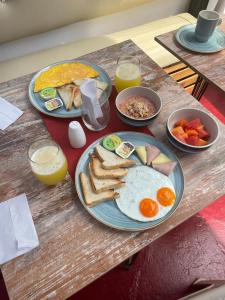 a table with two plates of breakfast food on it at Candilejo Hotel Boutique in Cartagena de Indias