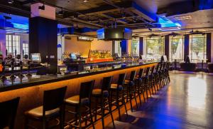 a bar with a bunch of chairs sitting at it at Clayton Hotel Burlington Road in Dublin