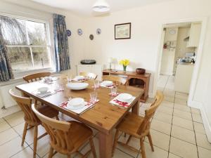 a kitchen and dining room with a wooden table and chairs at The Lock House in Gloucester