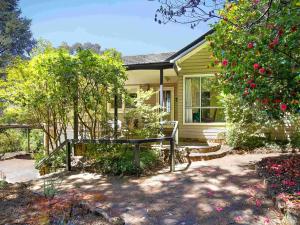 a yellow house with a bench in front of it at The Nineteenth in Blackheath