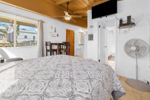 a bedroom with a large bed and a fan at Sweet Sunset Studio in San Diego