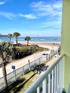 a balcony with a view of a beach and the ocean at Coastal Cozy - Ocean View at Symphony Beach Club in Ormond Beach