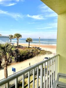a balcony with a view of a beach and the ocean at Coastal Cozy - Ocean View at Symphony Beach Club in Ormond Beach