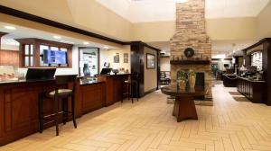 a lobby with a bar and a fireplace at Sonesta ES Suites Chatsworth in Chatsworth