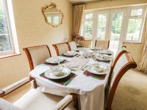 a dining room table with plates and dishes on it at Holly Bank in Etton