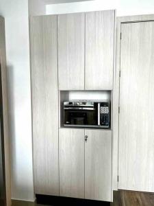 a microwave in a cabinet in a kitchen at Luxury apartment with balcony and view in Quito +67 photos