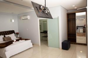 a bedroom with a bed and a ceiling fan at Hotel Araguaia in Palmas