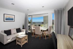 a living room with a couch and a table at Cashmere Heights in Christchurch