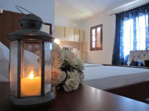 
a candle is lit on a table in a room at Tilos Fantasy in Livadia
