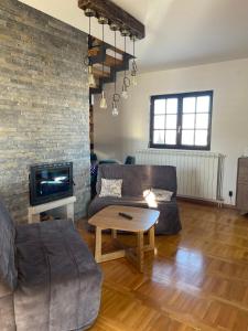 a living room with a couch and a table at Mountain Villa Zlatibor in Zlatibor