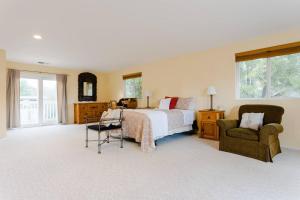 a large bedroom with a bed and a chair at Sonoma Wine Country Bungalow in Sonoma