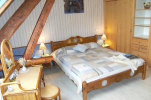 a bedroom with a bed and two chairs and a table at Le Clos de Lumière in La Roche-des-Arnauds