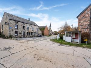 an empty street in a small town with a church at Gite in Lessive close to Rochefort in Rochefort