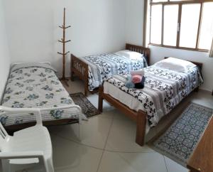 A bed or beds in a room at Casa residencial no centro de Guaratinguetá