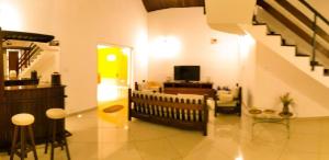 a living room with a staircase and a living room at Casa residencial no centro de Guaratinguetá in Guaratinguetá