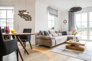 a living room with a couch and a table at Ferienwohnung Duene 2_2 in Groß Kirr