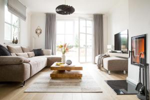 a living room with a couch and a table at Ferienwohnung Duene 2_2 in Groß Kirr