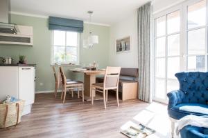 a kitchen and dining room with a table and chairs at Ferienhaus Haubenlerche 14 in Fuhlendorf