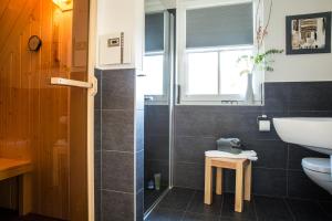 a bathroom with a sink and a toilet at Ferienhaus Schilfrohrsaenger 45 in Fuhlendorf +30 photos