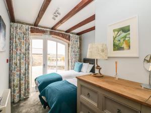a bedroom with two beds and a window at Helford in Penryn