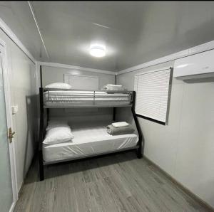 a small room with three bunk beds in it at Las Casitas de Village in Carolina