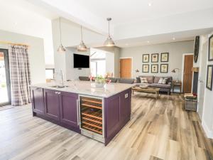 a kitchen with a purple island in a living room at Lake View in Penrith