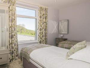 a bedroom with two beds and a window at Lake View in Penrith