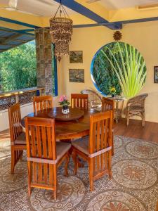 a dining room with a wooden table and chairs at Blue Moon Guesthouse in Puerto Princesa City