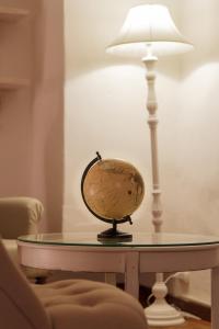 a table with a lamp and a globe on it at Eden Loft Firenze in Florence