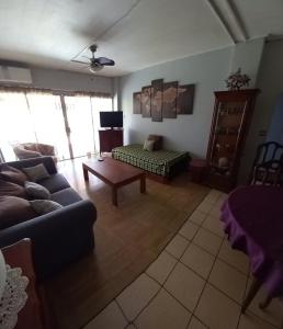 a living room with a couch and a coffee table at soleil de Pirae in Pirae
