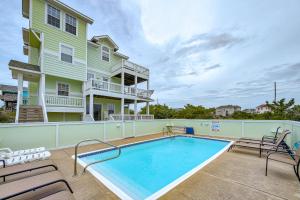 a house with a swimming pool and patio furniture at Xactly Wright 760 in Avon