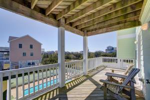 a porch with two chairs and a table on it at Xactly Wright 760 in Avon