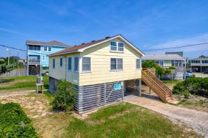 a tiny house with a staircase in a yard at Sea View 44 in Avon