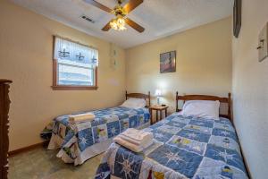 a bedroom with two beds and a ceiling fan at Even Flow 94 in Buxton