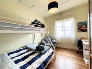 A bunk bed or bunk beds in a room at Nautique Beach House