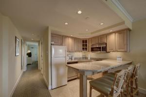 a kitchen with a white refrigerator and a counter at Bodie's Anchor 141 in Hatteras