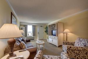 a living room with a couch and a tv at Bodie's Anchor 141 in Hatteras