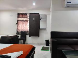 a room with a bed and a desk and a chair at Hotel Destiny in Visakhapatnam