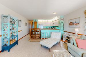 a living room with a couch and a kitchen at Oceanside Fun 952 RR in Rodanthe