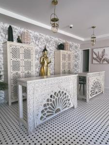a white altar with a statue in a room at Hotel Boutique Casa Hendaus - Adults Only in San Andrés