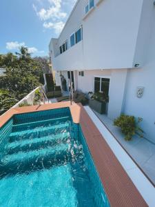 a swimming pool in front of a house at Hotel Boutique Casa Hendaus - Adults Only in San Andrés