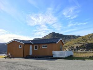 a house with a bike parked in front of it at Nordkapp Camping in Honningsvåg