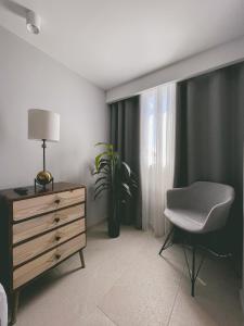 a bedroom with a dresser and a chair and a plant at Hotel Boutique Casa Hendaus - Adults Only in San Andrés +56 photos